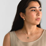 Model wearing the Hygge Bloom Necklace in gold fill, reflecting a sense of mindfulness and connection.