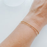 Model wearing the Livy Link Bracelet in gold fill, styled with an elegant yet casual outfit.