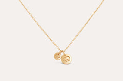 Mama Bear Baby Bear necklace layered with other delicate gold jewelry for a stylish look.