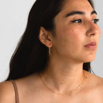 Monroe Earrings in 14k gold fill, worn view, showcasing the design from the front.