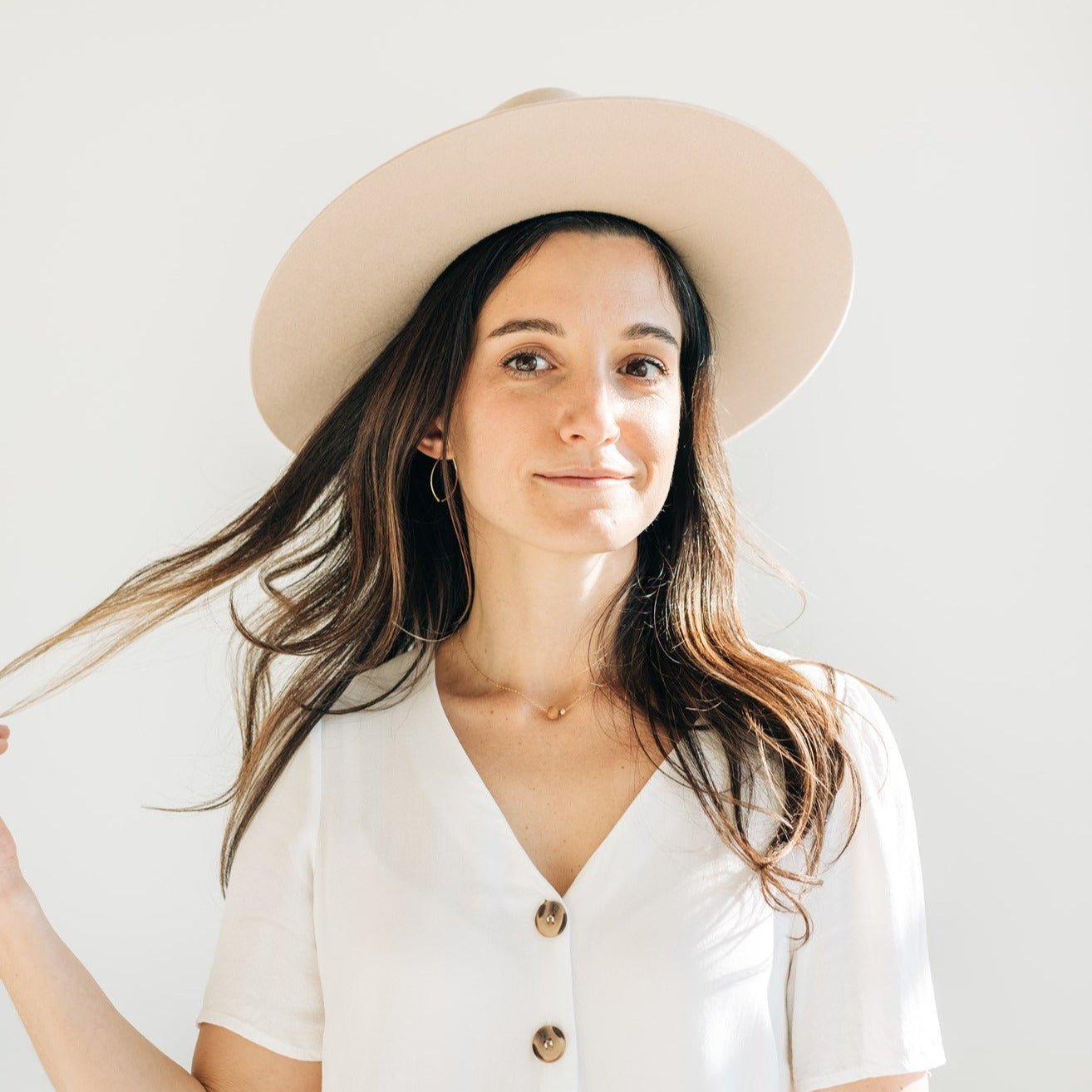 Model wearing handcrafted Sandalwood Bead Necklace by Sheena Marshall Jewelry with a gold-filled chain and ethically sourced sandalwood bead for a refined, minimalist style.