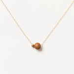 Handcrafted Sandalwood Bead Necklace by Sheena Marshall Jewelry featuring a 7mm ethically sourced sandalwood bead and 4mm gold-filled sphere on a delicate chain.