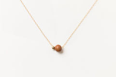 Handcrafted Sandalwood Bead Necklace by Sheena Marshall Jewelry featuring a 7mm ethically sourced sandalwood bead and 4mm gold-filled sphere on a delicate chain.